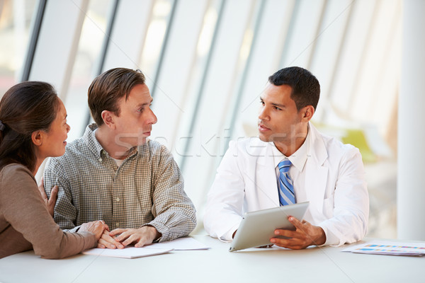 Stock photo: Doctor Using Tablet Computer Discussing Treatment With Patients