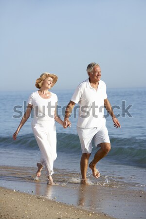 Senior Couple Having Fun On Beach Holiday Stock photo © monkey_business