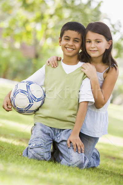 Dzieci gry piłka nożna parku patrząc Zdjęcia stock © monkey_business