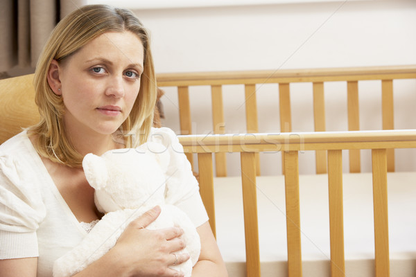 Stock photo: Sad Mother Sitting In Empty Nursery