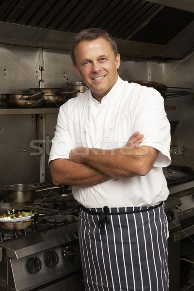 Male Chef Standing Next To Cooker In Restaurant Kitchen Stock photo © monkey_business