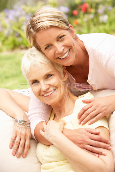 Stock photo: Senior Woman And Adult Daughter Relaxing In Garden