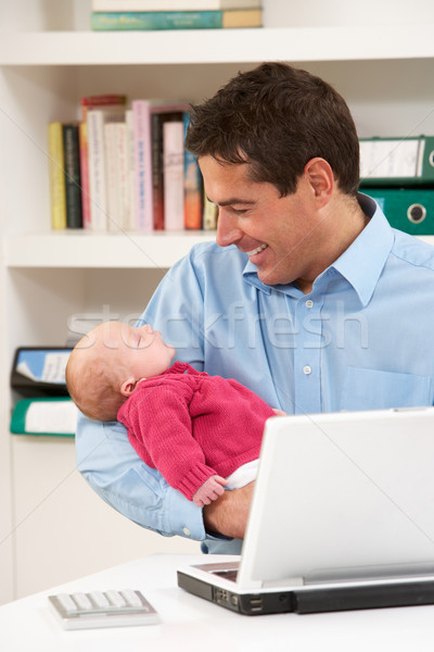 Father With Newborn Baby Working From Home Using Laptop Stock photo © monkey_business