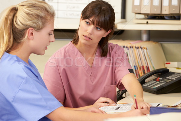 Stock photo: Two Nurses Working At Nurses Station