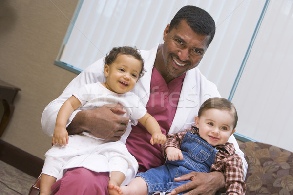 Stock photo: Consultant holding two IVF children