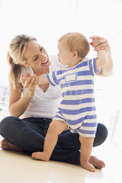 Mother and baby indoors playing and smiling Stock photo © monkey_business