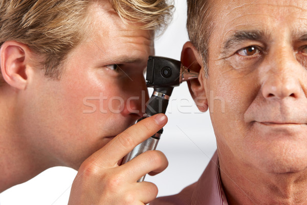 Orvos megvizsgál férfi fülek férfiak dolgozik Stock fotó © monkey_business