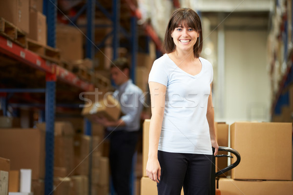 Businesswoman Pulling Pallet In Warehouse Stock photo © monkey_business