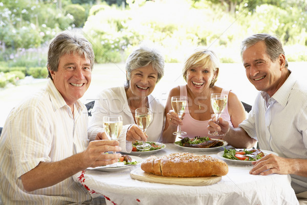 Friends Eating An Al Fresco Lunch, Holding Wineglasses Stock photo © monkey_business
