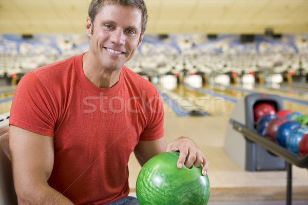 Young man holding a bowling ball in a bowling alley Stock photo © monkey_business