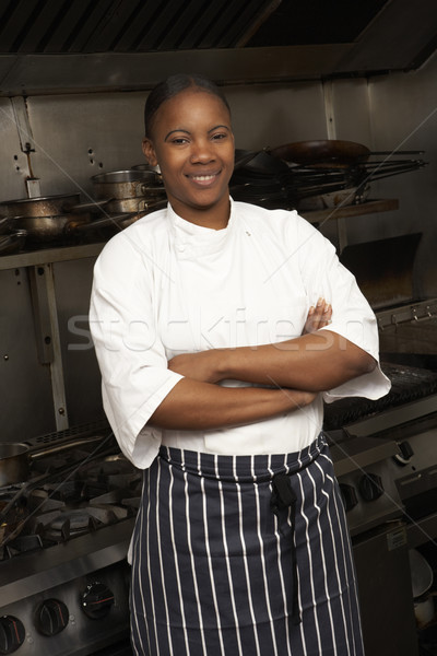 Female Chef Standing Next To Cooker In Restaurant Kitchen Stock photo © monkey_business