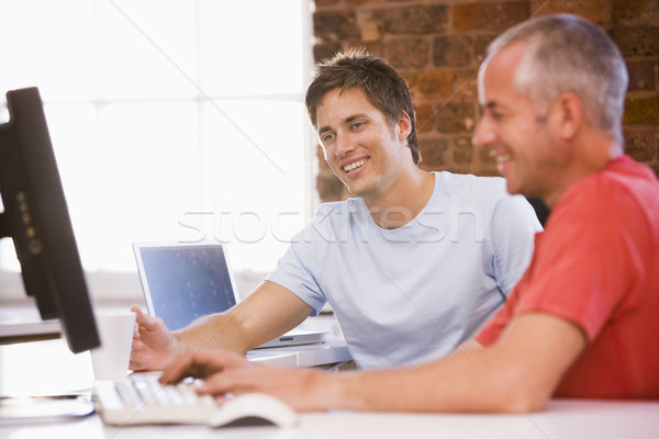 Dwa biznesmenów biuro wpisując komputera uśmiechnięty Zdjęcia stock © monkey_business
