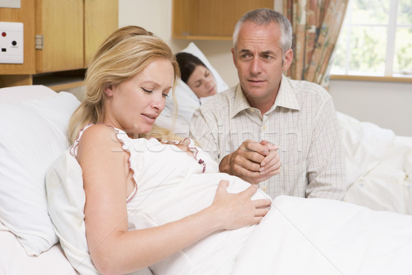 Pregnant woman in pain with husband in hospital Stock photo © monkey_business