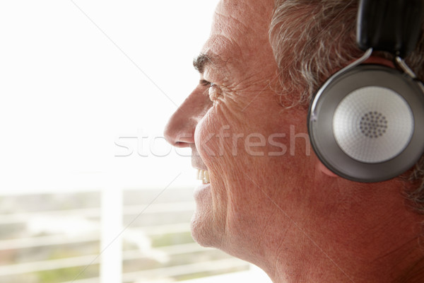 Mid age man wearing headphones Stock photo © monkey_business