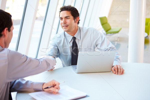 Two Businessmen Having Meeting Around Table In Modern Office Stock photo © monkey_business