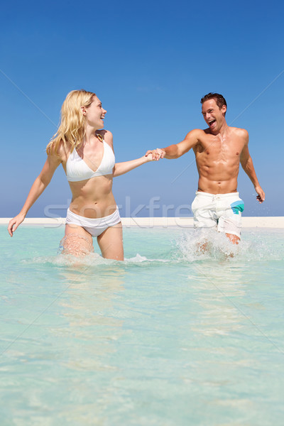 Couple Having Fun In Sea On Beach Holiday Stock photo © monkey_business