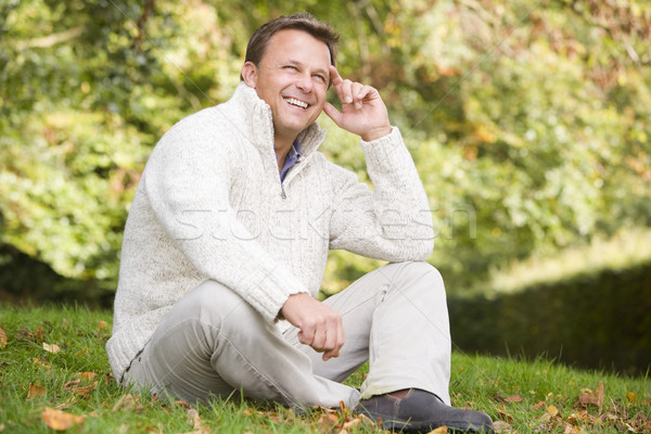 Mann Sitzung außerhalb Herbst Landschaft Gras Stock foto © monkey_business