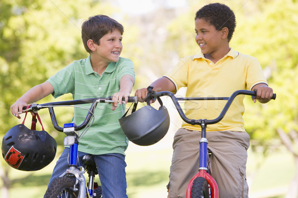 Stock photo: Two young boys on bicycles outdoors smiling