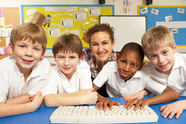 Schoolchildren in IT Class Using Computers with teacher Stock photo © monkey_business