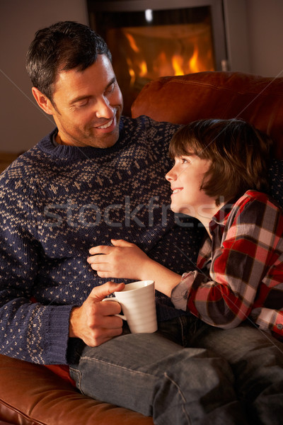 [[stock_photo]]: Père · en · fils · détente · boisson · chaude · confortable · feu · homme