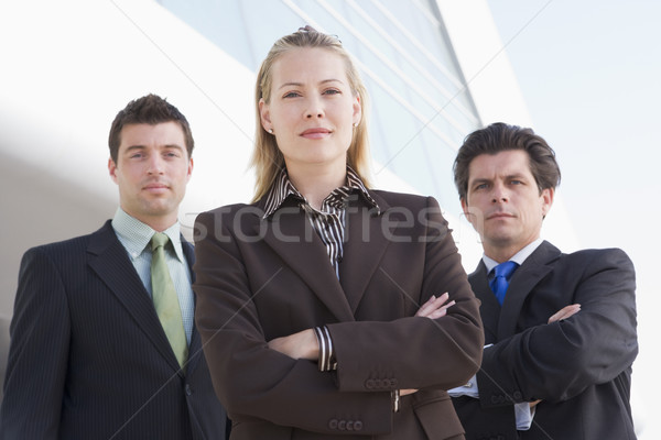 Stock photo: Three businesspeople standing outdoors by building