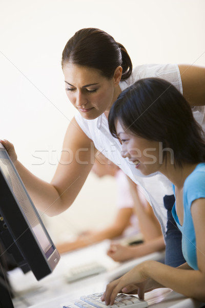 Two women in computer room where one is assisting the other Stock photo © monkey_business