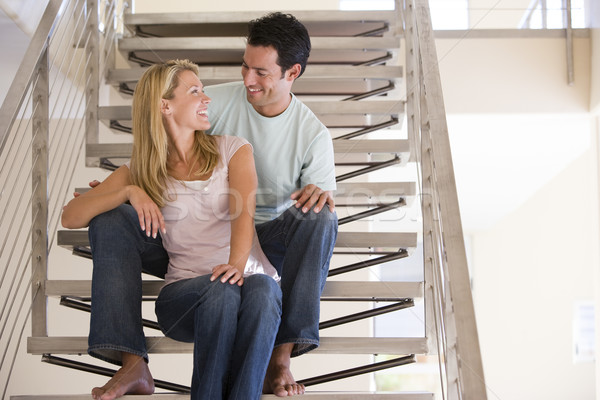 Couple sitting on staircase smiling Stock photo © monkey_business
