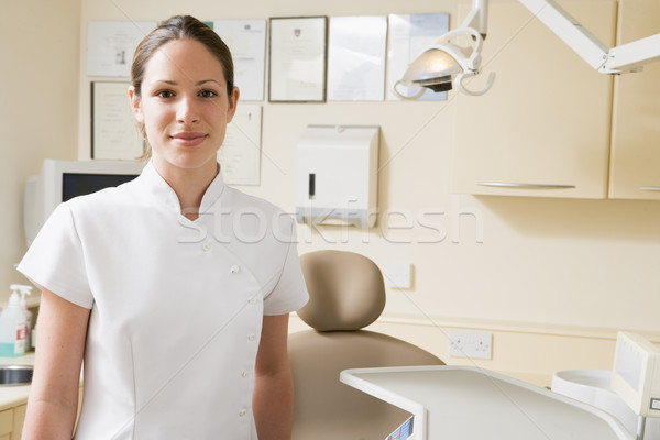 Stock photo: Dental assistant in exam room smiling