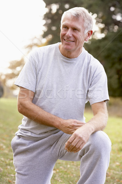 Portrait Of Senior Man Kneeling In Park Stock photo © monkey_business