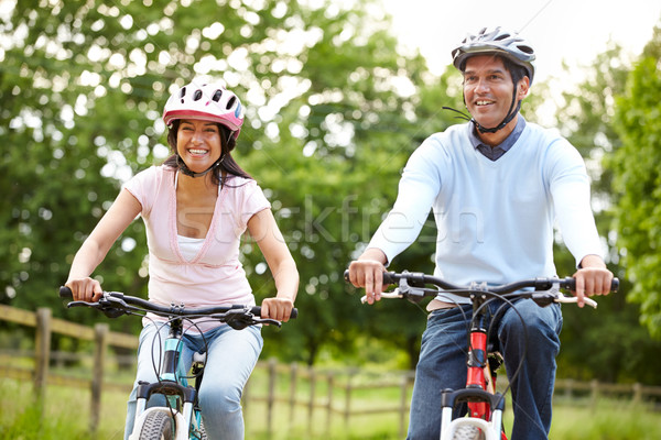 Indian Couple On Cycle Ride In Countryside Stock photo © monkey_business