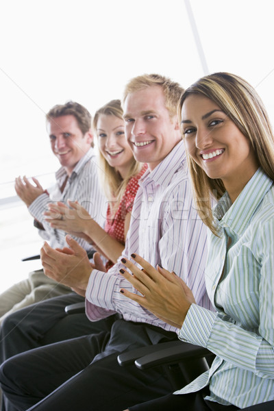 Four businesspeople applauding indoors smiling Stock photo © monkey_business