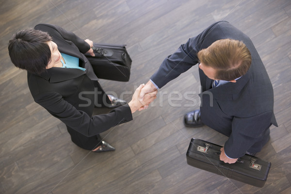Zwei Geschäftsleute drinnen Händeschütteln Mann Sitzung Stock foto © monkey_business