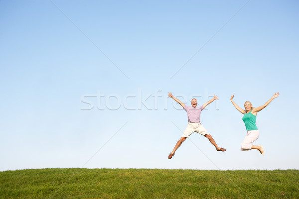 Senior couple jumping in air Stock photo © monkey_business