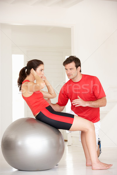 Woman with personal trainer in home gym Stock photo © monkey_business