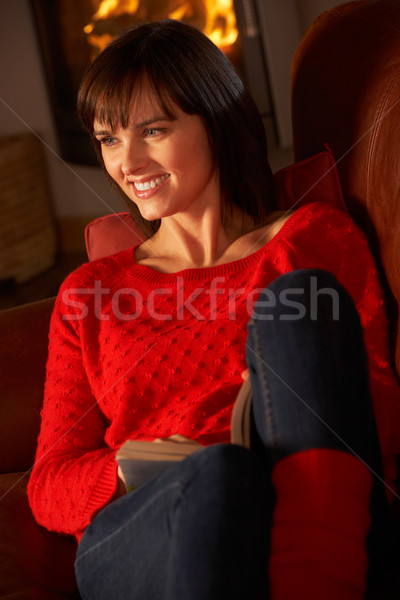 Middle Aged Woman Relaxing With Book By Cosy Log Fire Stock photo © monkey_business