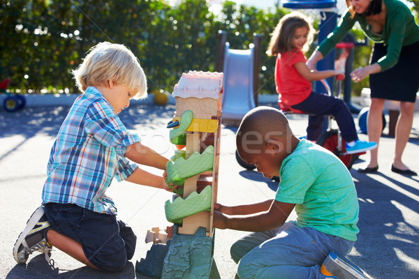 Due ragazzi giocare giocattolo parco giochi ragazza Foto d'archivio © monkey_business