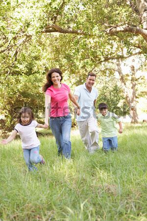 Mother and children walking along woodland path Stock photo © monkey_business