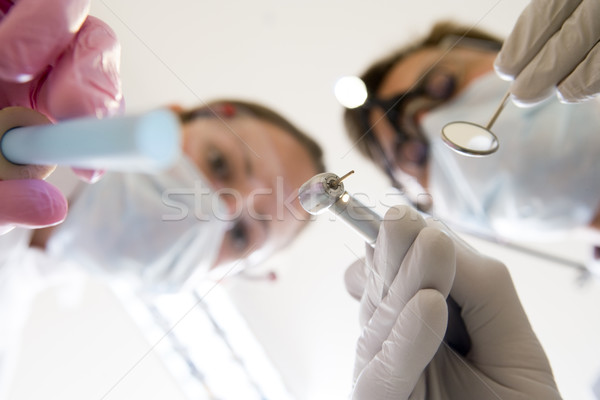 Stock photo: Dentist and assistant holding pick and mirror