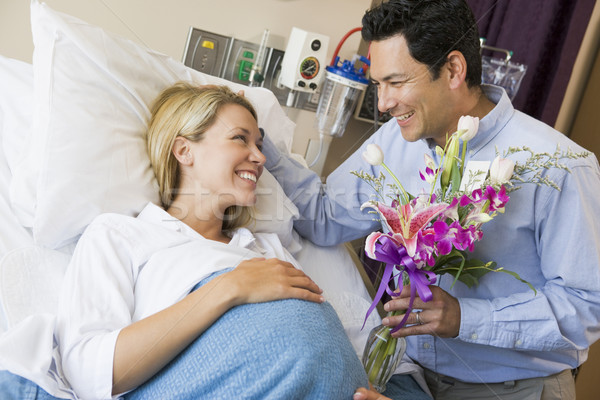Man Giving His Pregnant Wife Flowers Stock photo © monkey_business