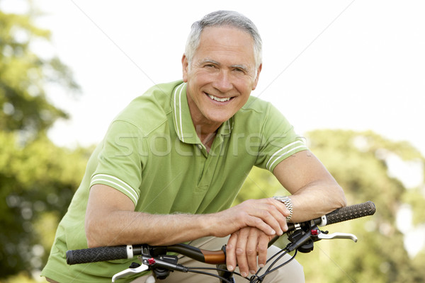 Stock photo: Portrait of man riding cycle in countryside
