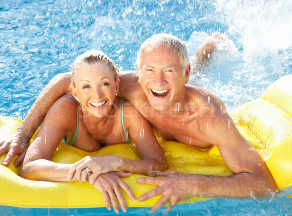 Senior couple having fun in pool Stock photo © monkey_business