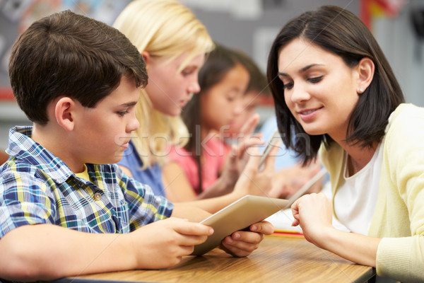 Stock photo: Pupils In Class Using Digital Tablet With Teacher
