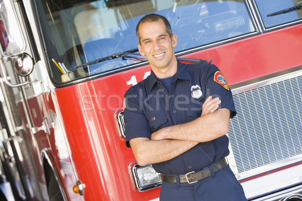 Portrait of a firefighter by a fire engine Stock photo © monkey_business