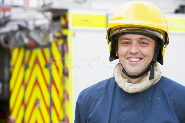 Portrait of a firefighter standing in front of a fire engine Stock photo © monkey_business