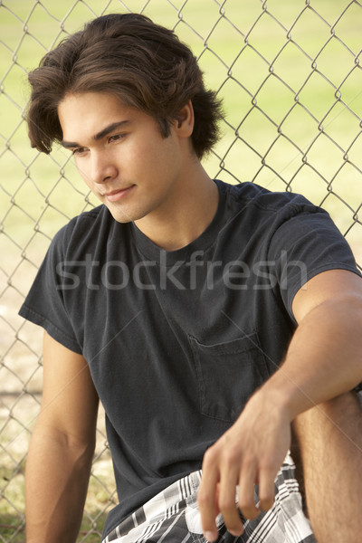 Tizenéves fiú ül játszótér férfi boldog tini Stock fotó © monkey_business