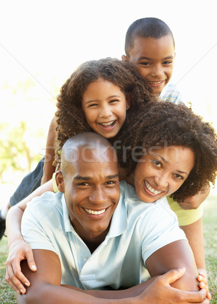 Portrait of Happy Family Piled Up In Park Stock photo © monkey_business