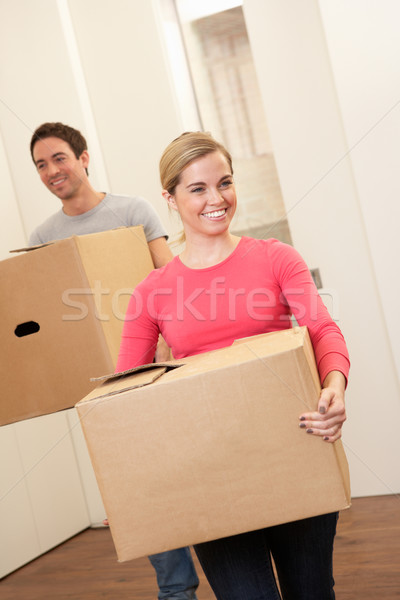 Young couple on moving day carrying cardboard boxes Stock photo © monkey_business