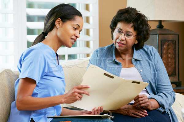 Stock photo: Nurse Discussing Records With Senior Female Patient During Home 