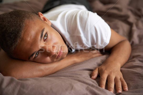 落ち込んで ベッド 悲しい 代 少年 ストックフォト © monkey_business