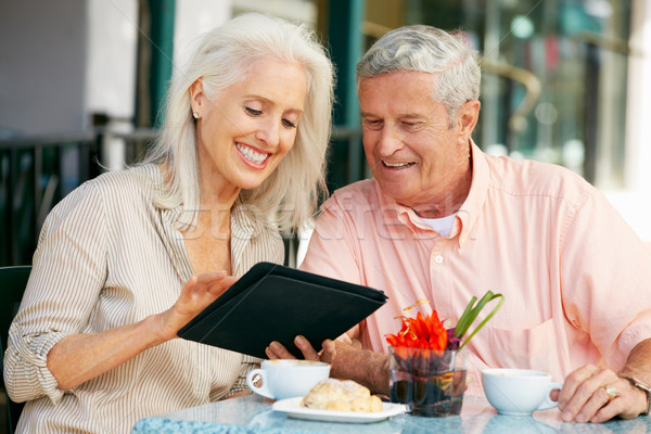 Senior Couple Using Tablet Computer At Outdoor Caf Stock photo © monkey_business